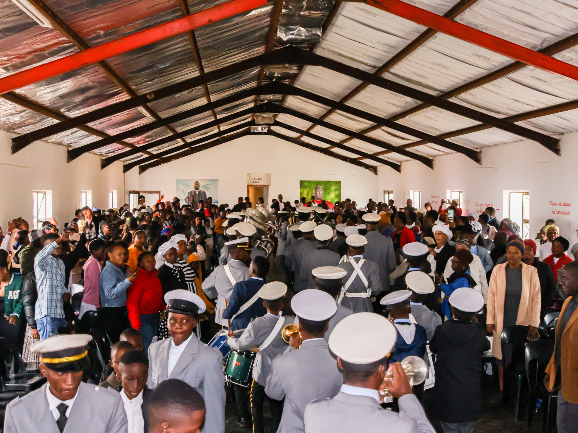 Congregation and brass band inside St Oaks Global Church of Christ